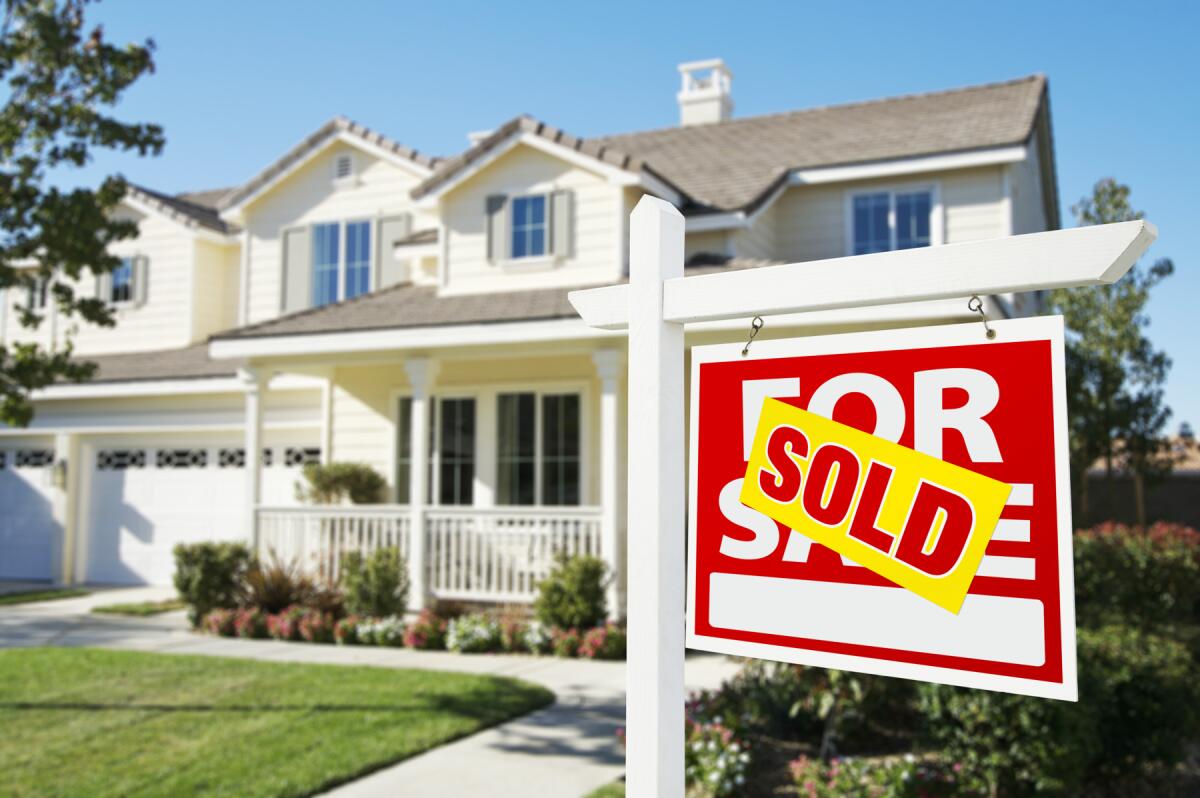 A sold sign in front of a Central Texas home